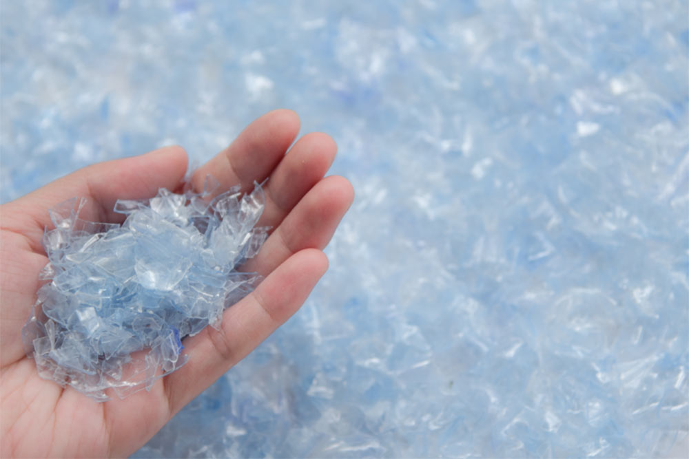 woman hand holding PET bottle flake